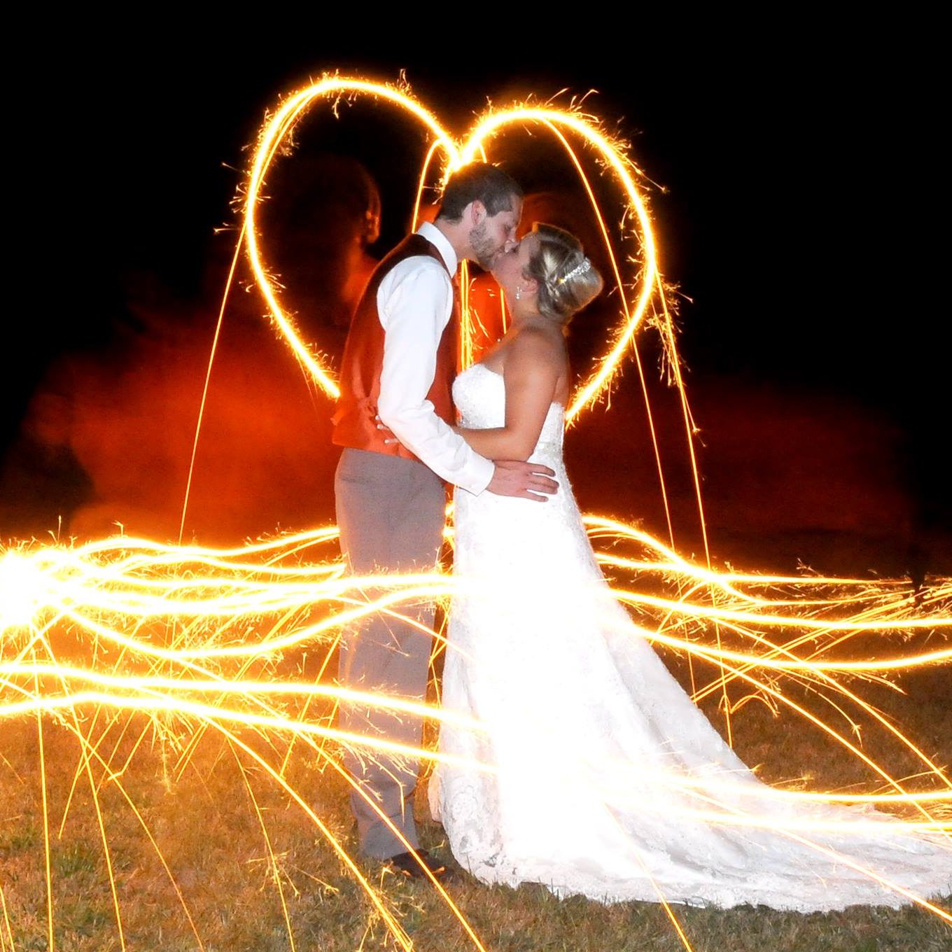 Wedding couple surrounded by sparklers